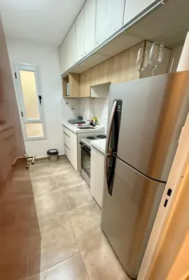 a kitchen with a stainless steel refrigerator at Departamento en el corazón de Nueva Cordoba SS8 in Cordoba