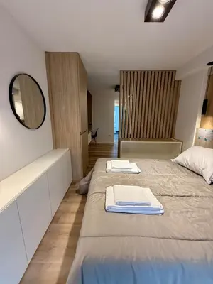 two beds in a room with a mirror and a mirror at Departamento en el corazón de Nueva Cordoba SS8 in Cordoba