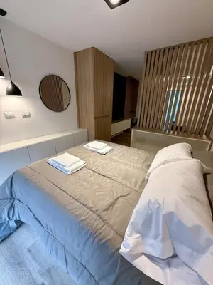 a bedroom with a bed with two towels on it at Departamento en el corazón de Nueva Cordoba SS8 in Cordoba