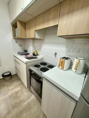 a kitchen with a stove and a counter top at Departamento en el corazón de Nueva Cordoba SS8 in Cordoba