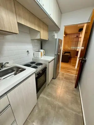 a kitchen with a sink and a stove top oven at Departamento en el corazón de Nueva Cordoba SS8 in Cordoba