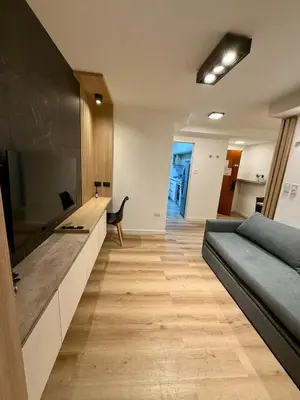 a living room with a couch and a flat screen tv at Departamento en el corazón de Nueva Cordoba SS8 in Cordoba