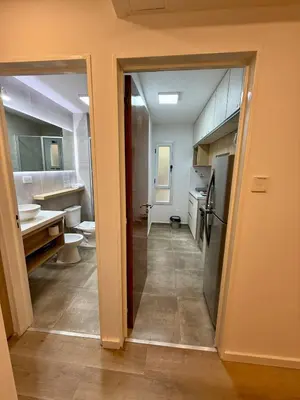 an open door to a bathroom with a sink at Departamento en el corazón de Nueva Cordoba SS8 in Cordoba