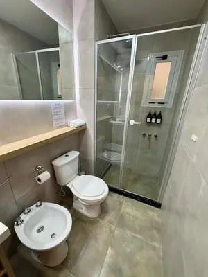 a bathroom with a toilet and a shower at Departamento en el corazón de Nueva Cordoba SS8 in Cordoba