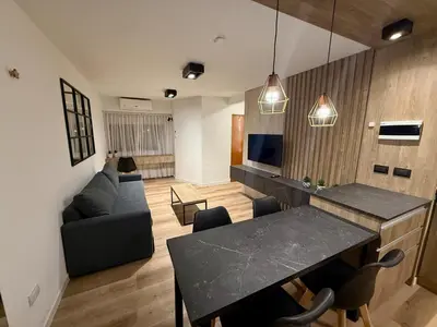 a living room with a table and a couch at Departamento Confortable en Nueva Cordoba SS9 in Cordoba
