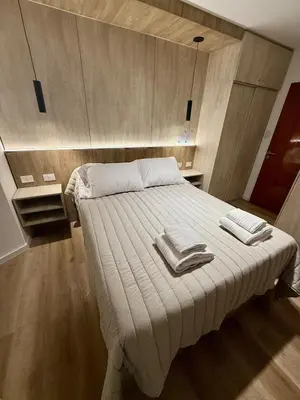 a bedroom with a bed with two towels on it at Departamento Confortable en Nueva Cordoba SS9 in Cordoba