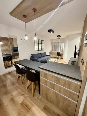 a kitchen and living room with a table and a couch at Departamento Confortable en Nueva Cordoba SS9 in Cordoba