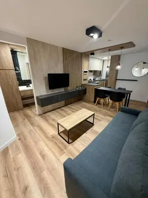 a living room with a blue couch and a table at Departamento Confortable en Nueva Cordoba SS9 in Cordoba