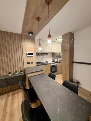 a kitchen with a table and chairs in a room at Departamento Confortable en Nueva Cordoba SS9 in Cordoba