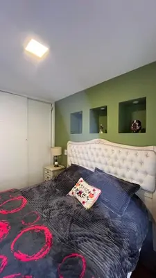 a bedroom with a large bed with a white headboard at Departamento en Guemes in Cordoba