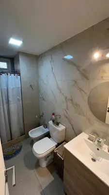 a bathroom with a toilet and a sink at Departamento en Guemes in Cordoba