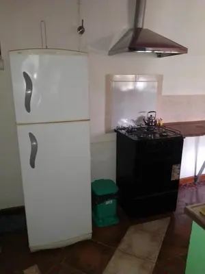 a kitchen with a white refrigerator and a stove at lodelrafa in San Lorenzo