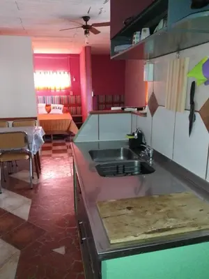 a kitchen with a sink and a table in a room at lodelrafa in San Lorenzo