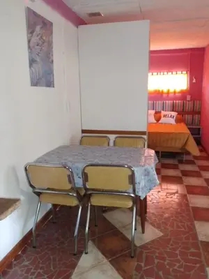 a room with a table and chairs and a bed at lodelrafa in San Lorenzo