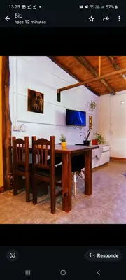 a dining room with a table and chairs at Departamento katzen in Alta Gracia