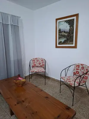 a living room with a wooden table and two chairs at Celestina 1 in Cordoba