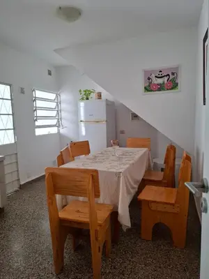 a dining room with a table and wooden chairs at Celestina 1 in Cordoba