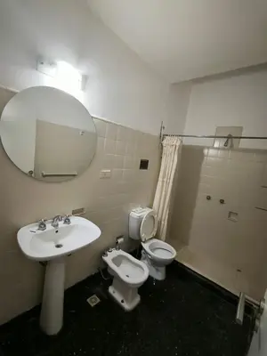 a bathroom with a sink and a toilet and a mirror at Celestina 1 in Cordoba