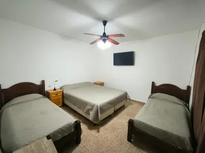 a room with two beds and a ceiling fan at Celestina 1 in Cordoba