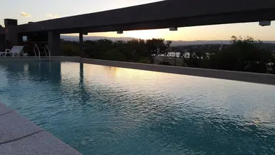 a swimming pool with a view of the city at Amplio departamento frente al lago-seguridad 24hs in Villa Carlos Paz