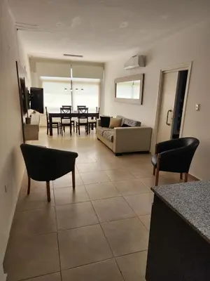 a living room with a couch and a table at Amplio departamento frente al lago-seguridad 24hs in Villa Carlos Paz
