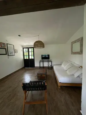 a living room with a bed and a table at Casa calma in Villa de Las Rosas