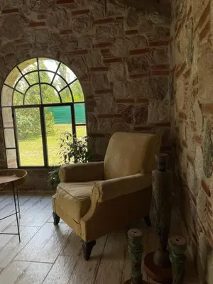 a couch sitting in a room with a window at Casa calma in Villa de Las Rosas