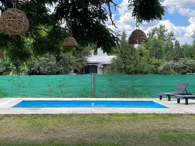 a swimming pool with a bench and a fence at Casa calma in Villa de Las Rosas