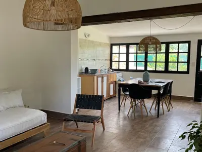 a living room with a table and a kitchen at Casa calma in Villa de Las Rosas