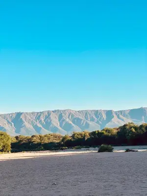 a large body of water with mountains in the background at La Casa De Juan in Mina Clavero