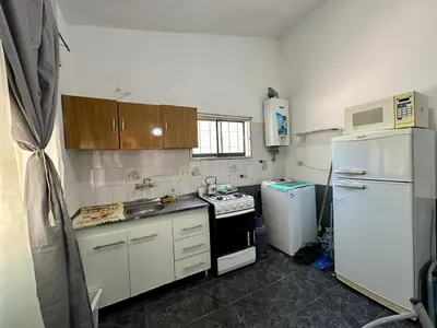 a kitchen with a white refrigerator and a stove at La Casa De Juan in Mina Clavero
