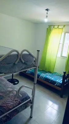 a room with two bunk beds and a window at La Casa De Juan in Mina Clavero