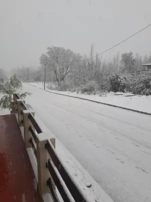a snow covered road with a fence next to it at Posada Villa Yacanto in Villa Yacanto