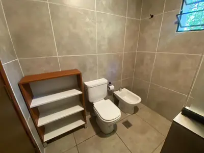 a bathroom with a toilet and a sink at Chalet Fratelli Rigoni in Villa Ciudad Parque
