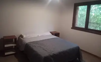 a bedroom with a bed and a window at Chalet Fratelli Rigoni in Villa Ciudad Parque