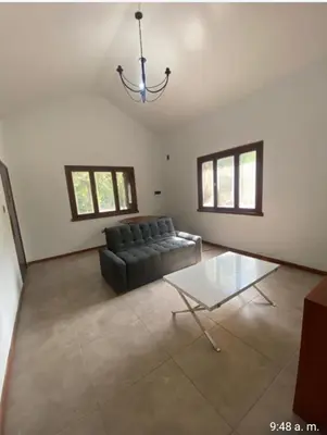 a living room with a couch and a glass table at Chalet Fratelli Rigoni in Villa Ciudad Parque