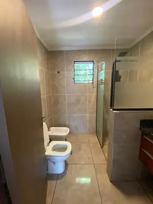 a bathroom with a white toilet and a shower at Chalet Fratelli Rigoni in Villa Ciudad Parque
