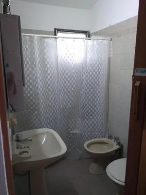 a bathroom with a shower and a toilet and a sink at Portal de las Sierras in Bialet Massé