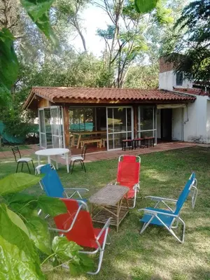 a group of chairs and a table in the yard at Portal de las Sierras in Bialet Massé