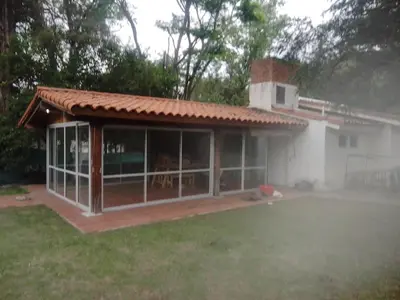 a house with a large screened in porch at Portal de las Sierras in Bialet Massé