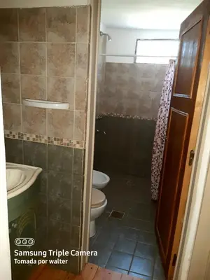 a bathroom with a toilet and a sink at La Cabaña de EMI in La Bolsa