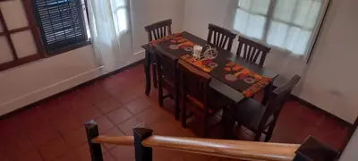 a dining room with a table and chairs in a room at La Cabaña de EMI in La Bolsa