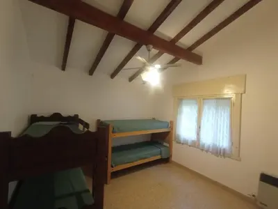 a room with two bunk beds and a window at Portal de las sierras in Bialet Massé
