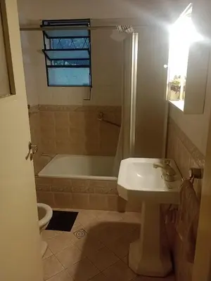 a bathroom with a tub and a sink and a toilet at Portal de las sierras in Bialet Massé