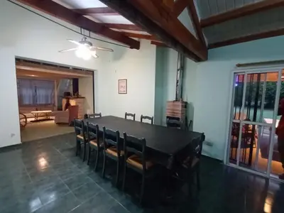 a dining room with a black table and chairs at Portal de las sierras in Bialet Massé