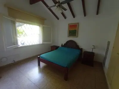 a bedroom with a bed and a window at Portal de las sierras in Bialet Massé