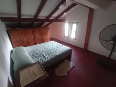a bedroom with a bed in a room with a fan at Portal de las sierras in Bialet Massé
