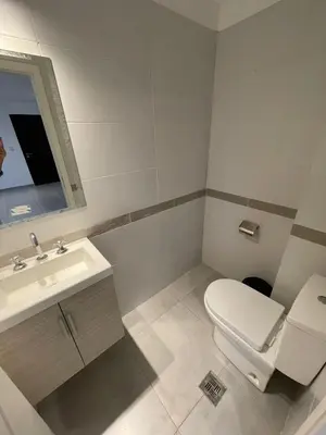 a bathroom with a white toilet and a sink at DEPARTAMENTO Villa Carlos Paz altos de Lincoln in Villa Carlos Paz