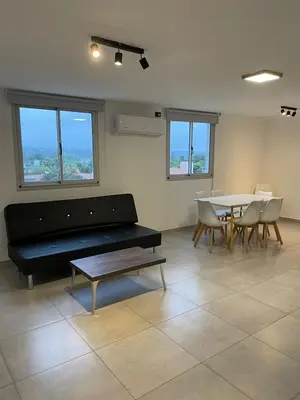 a living room with a couch and a table and chairs at DEPARTAMENTO Villa Carlos Paz altos de Lincoln in Villa Carlos Paz