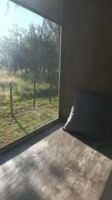 a bedroom with a window looking out at a field at Las Lomitas in Carpintería